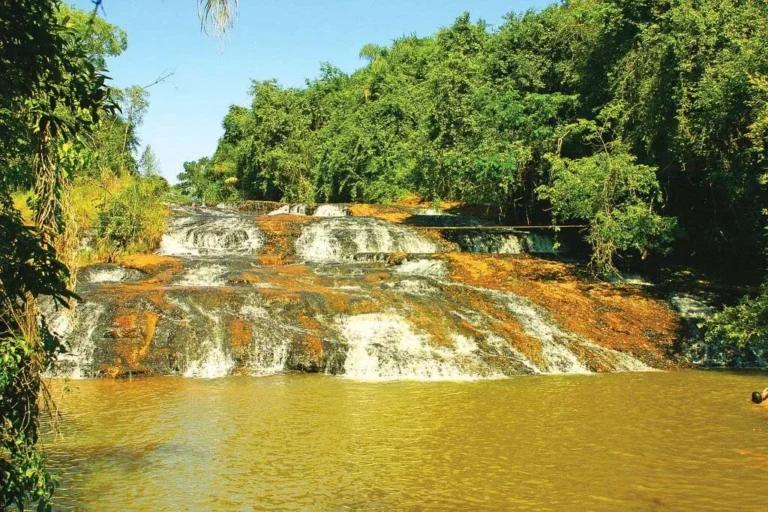 Cachoeira Escorregador, com a água descendo em degraus de pedra larga, ideal para escorregar.